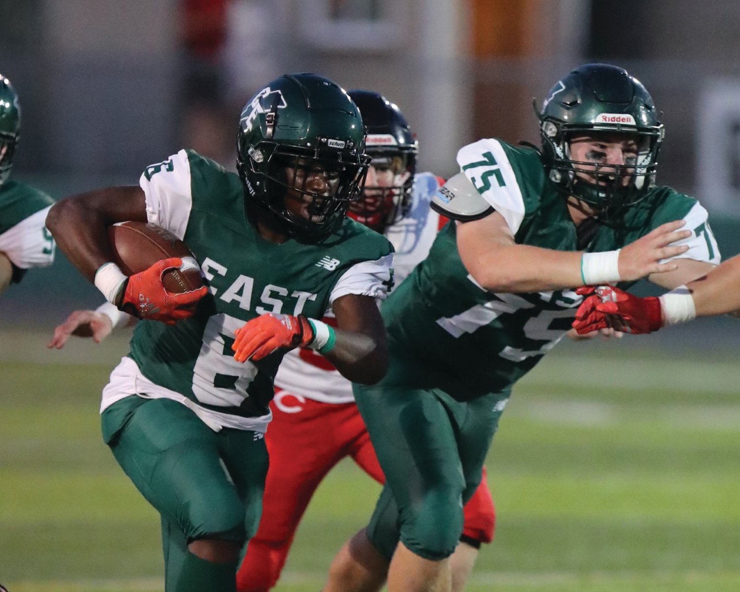 UP THE GUT: Cranston East’s A’driahn Foreman picks up some yards alongside Thomas Roche.